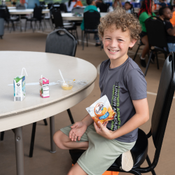 Child at summer food site smiling
